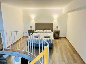 a bedroom with a bed and two night stands at Charme unique sous les remparts in Châteauneuf-de-Gadagne