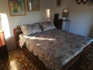 a bed in a bedroom with a bedspread on it at Villa Cenate in Nardò