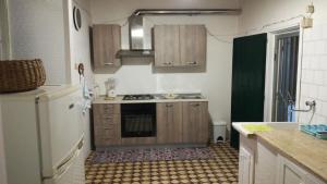 a kitchen with wooden cabinets and a stove top oven at Villa Cenate in Nardò