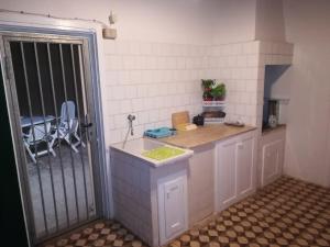 a small kitchen with a counter and a sink at Villa Cenate in Nardò