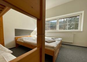 a bedroom with two bunk beds and a window at Penzion Kouty in Loučná nad Desnou +31 photos