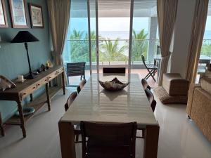 a living room with a table and a view of the ocean at Heavenly Hideaway in Nilaveli