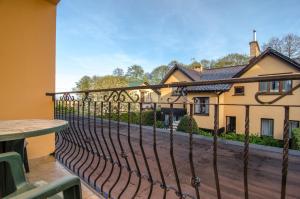 a balcony with a fence and a house at Willa Koron a Mielno in Mielno