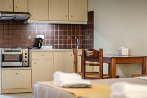 a kitchen with a table and a counter top at Eleni Suites Methoni in Methoni