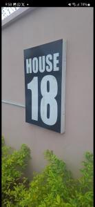 a house sign on the side of a building at promise hotel gbagada in Lagos