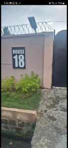 a house sign on the side of a building at promise hotel gbagada in Lagos