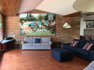 a living room with a large painting on the wall at Villa Sibel con piscina in Versilia in Massa
