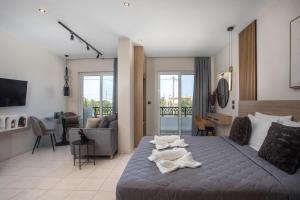 a bedroom with a bed with towels on it at JnS Premium Stay in Faliraki