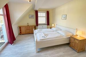 a bedroom with a large bed and a window at Holiday-2 in Prerow