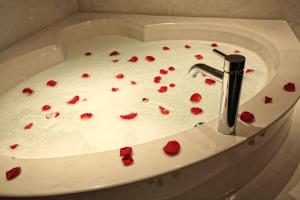 a sink with red rose petals in it at Century Casino & Hotel Edmonton in Edmonton +16 photos
