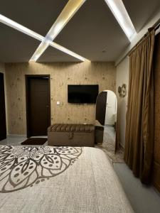a living room with a large bed and a couch at Luxury Sweet Apartments in Bahira town Lahore in Lahore