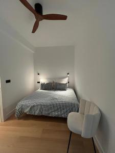 a bedroom with a bed and a ceiling fan at Bilbao City Center in Bilbao