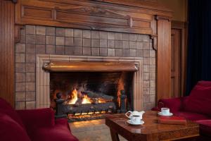 a fireplace in a living room with a fire at Arctic Club Hotel in Seattle