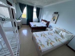 a small room with a bed and a couch at Masaki Anne house of Realty in Dar es Salaam