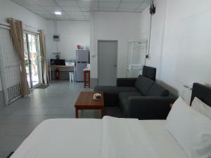 a living room with a couch and a table at The Rock Coco Villa in Ban Laem Pom