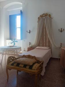 a bedroom with a bed and a table at Palazzo Caracciolo in Gerace