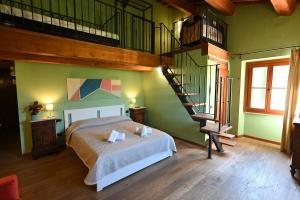 a bedroom with a bed and a spiral staircase at Villa al Furlo con Idromassaggio in Pagino