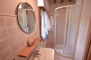 a bathroom with a sink and a mirror at Villa al Furlo con Idromassaggio in Pagino +37 photos