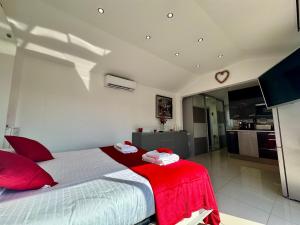 a bedroom with a large bed with a red blanket at Studio Love Room Rooftop Jacuzzi SCLS Rentals in Cannes