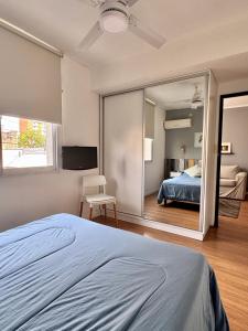 a bedroom with a bed and a large mirror at Departamento Peatonal I in Concordia