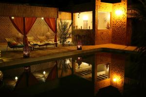 a night view of a house with a swimming pool at Dar Pienatcha in Zagora