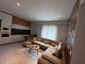 a living room with a couch and a table at Artemis Guesthouse in Gjirokastër