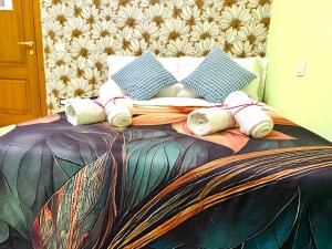 a bed with towels and pillows on it at Colosseum Star Guest House in Rome