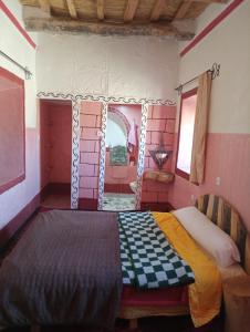 Postel nebo postele na pokoji v ubytování Dar Laayoune