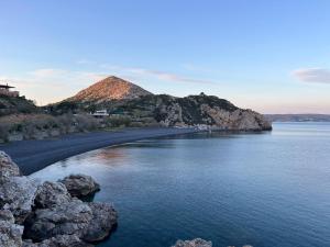 a large body of water with a mountain in the background at Kantouni house Chios in Pyrgi