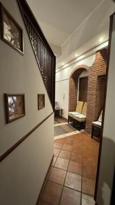 a hallway with a staircase and a brick wall at La Casa della Guida in Nicolosi