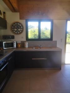 a kitchen with a sink and a window in it at La Crosette in La Thuile +22 photos