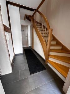 a hallway with a wooden staircase in a house at Ferienwohnung Ilke in Gersfeld