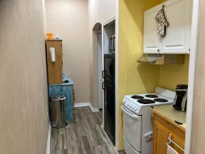 a small kitchen with a stove and a sink at Pet Friendly, Hot Tub, 8ml to Beach, 7ml to Sebastian in Sebastian +20 photos