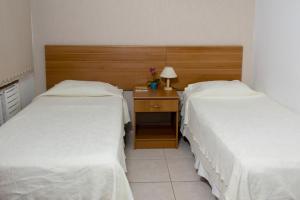 Postel nebo postele na pokoji v ubytování Hotel Pousada Bonita - 150m Metrô Paraiso e 1Km do inicio Av Paulista