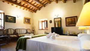 a bedroom with a large white bed in a room at Molí d'en Tarrés in Santa Cristina d'Aro