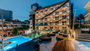 a hotel with a swimming pool in front of a building at Essence Hotel Boutique in Torremolinos