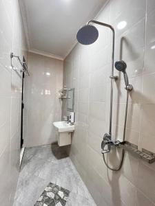 a bathroom with a shower and a sink at Hadraj Moshono Apartment2 in Arusha