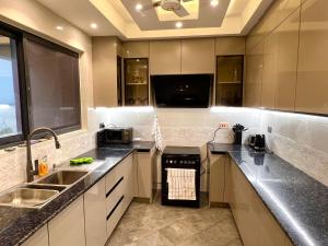 A kitchen or kitchenette at Coastal Serenity Suite Beach Front Apt