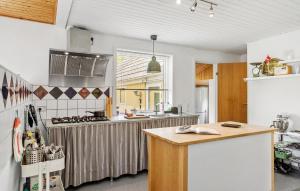 a kitchen with a counter top and a stove at 4 Bedroom Amazing Home In Østermarie in Østermarie +18 photos