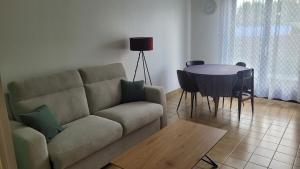 a living room with a couch and a table at kerNowen in Retiers +8 photos