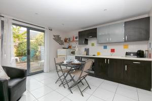 a kitchen with a table and chairs in a room at Le Refuge Salin Duplex Jardin in Batz-sur-Mer