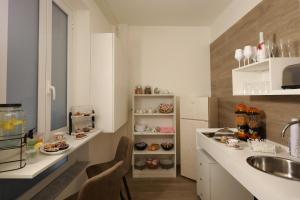 a kitchen with a sink and a counter with cookies at Le chiavi di Parthenope in Naples +40 photos