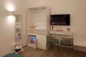 a room with a bedroom with a bed and a mirror at Le chiavi di Parthenope in Naples