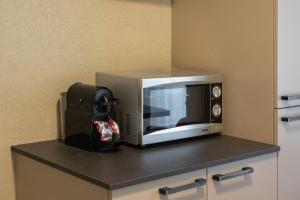 a microwave sitting on top of a counter at BetweenLakes Studio ground floor west in Interlaken