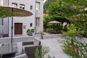 a patio with a table and chairs and a building at BetweenLakes Studio ground floor west in Interlaken