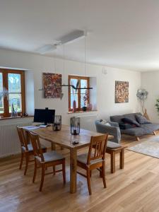 a living room with a table and chairs and a couch at Ferienwohnung Wein in Holzheim am Forst