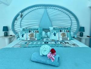 a bed with a stuffed animal sitting on a blue blanket at Sun Caraibes in Orient Bay