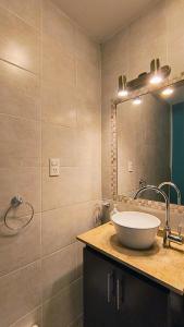 a bathroom with a sink and a mirror at Puerta Sur Apart in Malargüe +60 photos