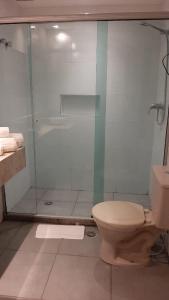 une salle de bain avec une douche en verre et des toilettes dans l'établissement WB Berrini São Paulo, à Água Boa
