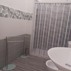 a bathroom with a toilet and a sink at Casa vacanze terrAmare in Avola +16 photos